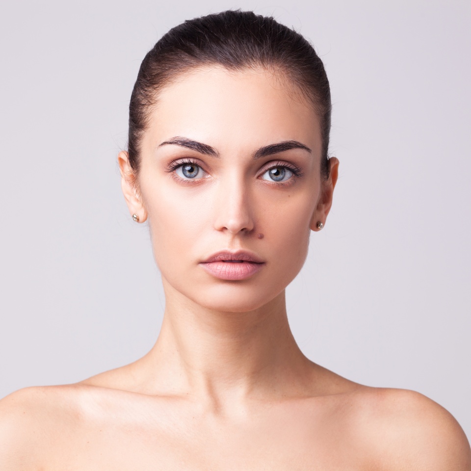 Closeup studio portrait of beautiful brunette woman isolated on white background