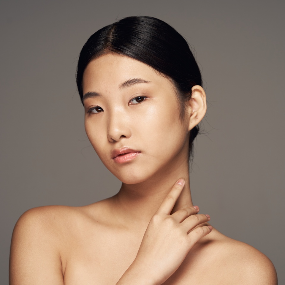 Beautiful woman charm naked shoulders Asian appearance nature cosmetics