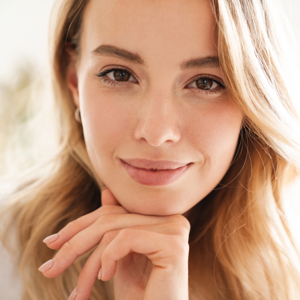Image of a cute positive beautiful woman indoors at home looking camera.