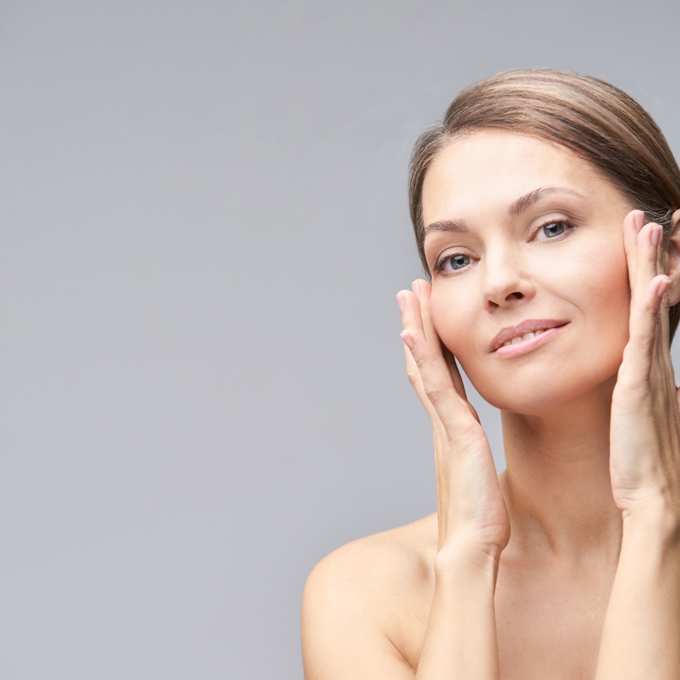 Pure skin care mature beauty portrait. Cosmetology plastic foundation. Anti wrinkle senior cream. Elegant Hands near female head. Medical treatment clinic. Woman nature makeup.