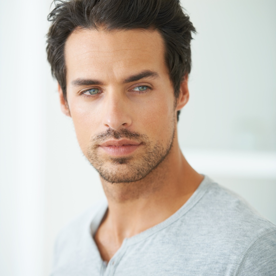 Hes a man of magnificence. Head and shoulder shot of a handsome young man looking away.