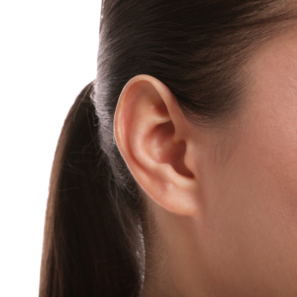 Woman on white background, closeup of ear