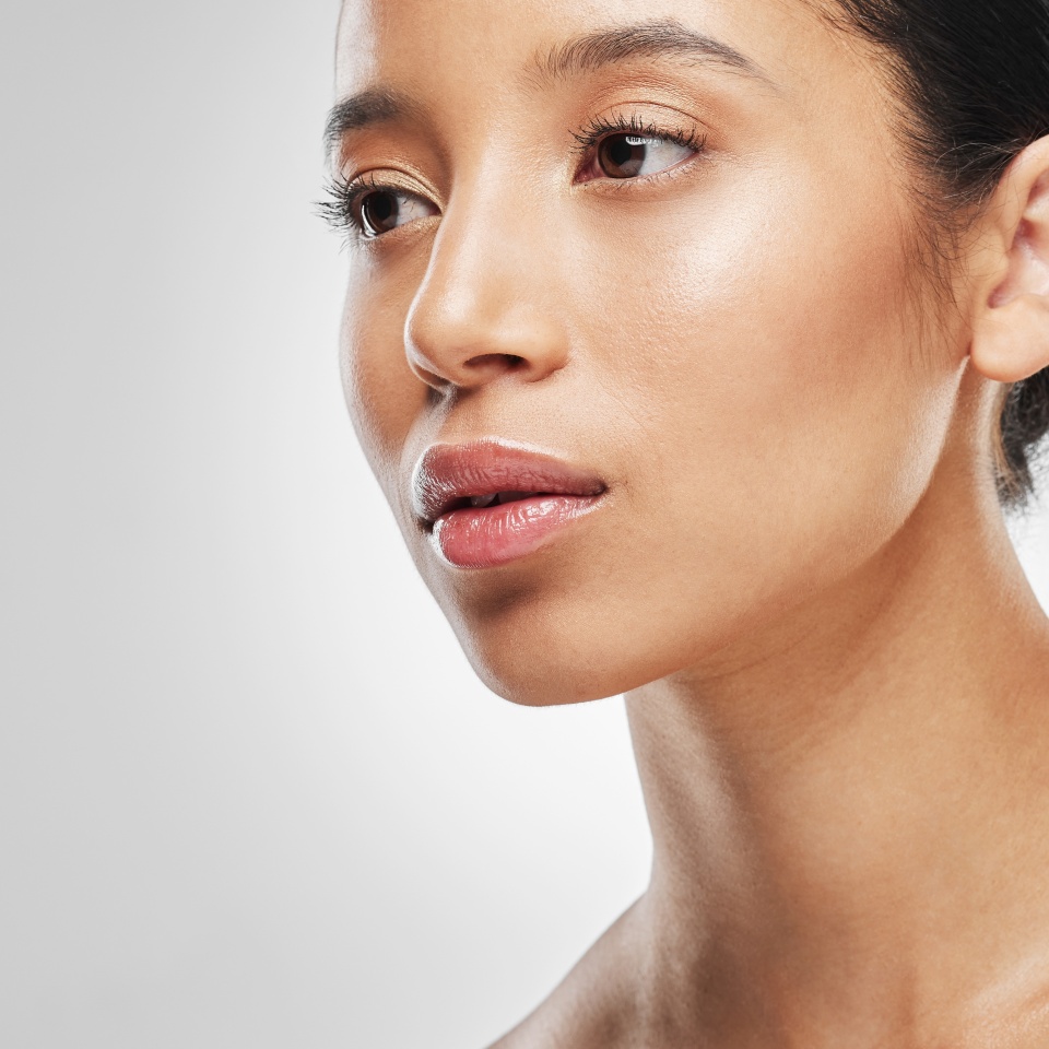 We all want that natural, healthy glow. Studio shot of an attractive young woman posing against a grey background.