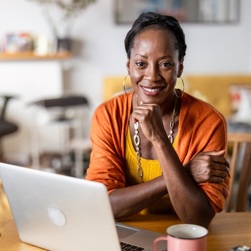 Mature woman working on laptop at home
