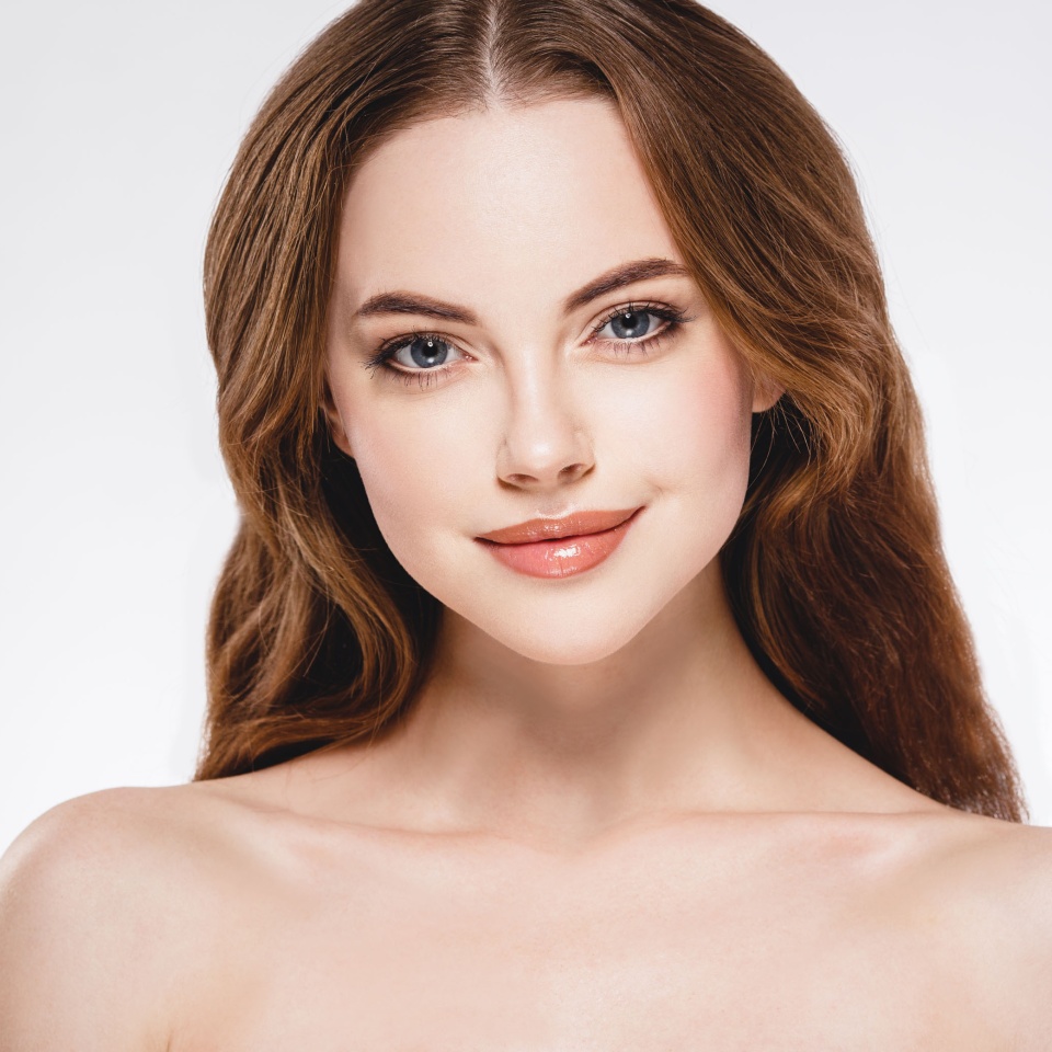 Beautiful woman face close up portrait young studio on white