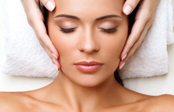 Face Massage. Close-up of a Young Woman Getting Spa Treatment.